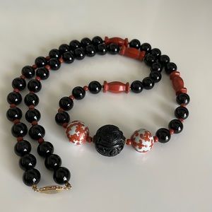 Vintage black orange white beaded necklace with gold toned clasp
